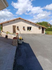 a building with windows on the side of a street at La PETITE MAISON in Gourdan-Polignan