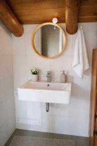a bathroom with a sink and a mirror at Villa Amalthia Panorama in Bozikás