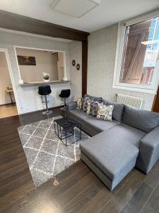 a living room with a couch and a table at Mc privé in Châtillon-Coligny