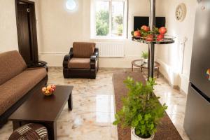 a living room with a couch and a table at apartament dato in Batumi +1 photo
