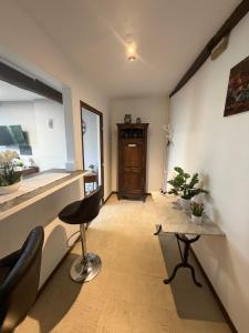 a living room with a chair and a table at Mc privé in Châtillon-Coligny +1 photo