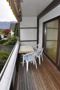 a patio with a table and chairs on a deck at Ferienhaus Bifang in Feldkirch