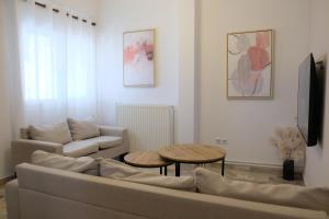 a living room with a couch and a table at Evia Blue Aura in Khrónia