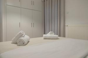 two towels sitting on a bed in a room at Evia Blue Aura in Khrónia