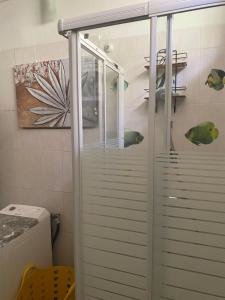 a shower in a bathroom with some fish on the wall at Bleu Ocean in Deshaies +20 photos