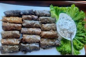 a plate of food with a pile of meat and lettuce at AGA HOTEL & Restaurant in Haghpat