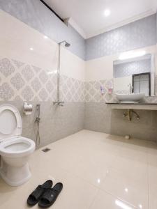 a bathroom with a toilet and a sink at Vision 2 Islamabad in Islamabad