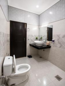 a bathroom with a toilet and a sink at Vision 2 Islamabad in Islamabad