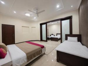 a hotel room with two beds and a bedroom at Vision 2 Islamabad in Islamabad