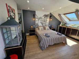 a bedroom with a bed and a large window at chambres de La Maillette in Locminé +5 photos