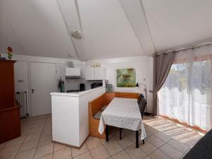 a kitchen with a table and a kitchen with a table and a room at Seestern 61 in Julianadorp