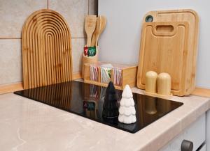 a kitchen counter with a sink and a cutting board at Apratman Shine Kula in Kula