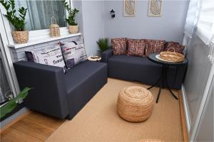 a living room with a couch and a table at Apratman Shine Kula in Kula
