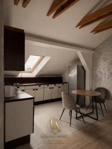 a kitchen with a table and a skylight at Luxury Apartments in Brčko