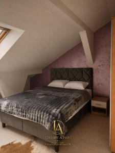 a bedroom with a large bed in a attic at Luxury Apartments in Brčko +3 photos