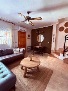 a living room with a couch and a table at Casa Midu Beachhouse 450m to the Beach in Los Alcázares