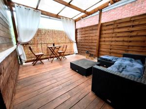 a large room with a wooden floor and a table at L'instant secret in Berlaimont
