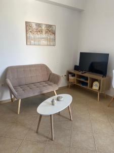 a living room with a couch and a coffee table at Casa Ariadne in Náxos