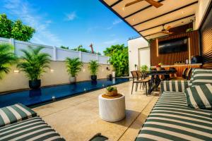an outdoor patio with a pool and a table and chairs at Royal Water Villa in Kiryat Ekron