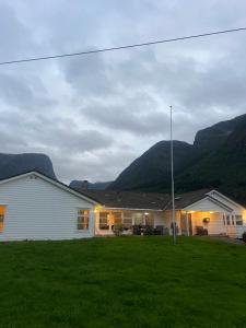 a white house with mountains in the background at Villa Fresvik in Fresvik