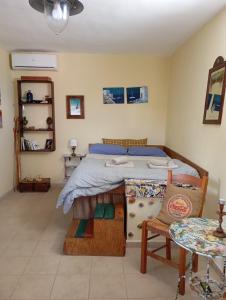 a bedroom with a bed and a table and a chair at gialos house in Livadia