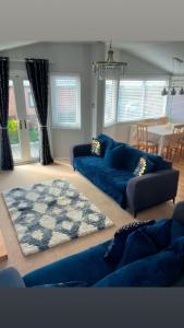a living room with blue couches and a rug at ocean view 15 in West Down