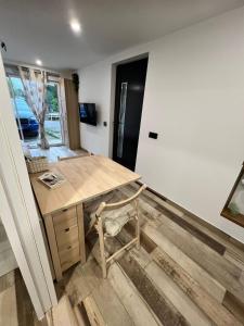 a room with a wooden desk and a refrigerator at Studio au Fil de l'eau in Langatte +4 photos
