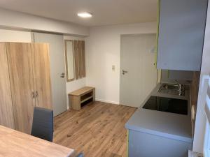 an empty kitchen with a counter and a wooden floor at Ferienwohnung Ulsteraue in Geisa