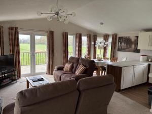 a living room with a couch and a table at par 3 in Wisbech