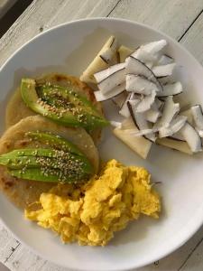 a plate of breakfast food with eggs and vegetables at Cabin near the beach in El Valle