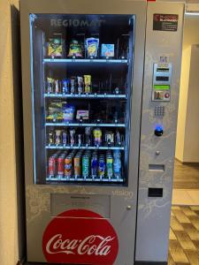 a cocacola soda vending machine with drinks in it at EC Hotel Elchingen in Elchingen +57 photos