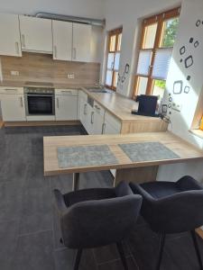 a kitchen with a wooden table and two chairs at LIV Retreat in Dietenhofen