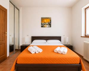 a bedroom with a bed with two towels on it at Apartment Alex 2 in Domaso in Domaso