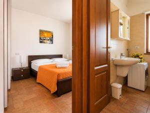 a bathroom with a bed and a sink in a room at Apartment Alex 2 in Domaso in Domaso +15 photos