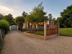 a house with a wooden fence in front of it at The Cove - Lake Eildon in Piries