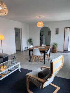 a living room with a table and chairs at GITE DE MIRAUVILLE in Apremont-la-Forêt