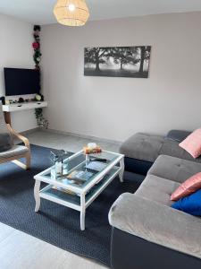 a living room with a couch and a coffee table at GITE DE MIRAUVILLE in Apremont-la-Forêt