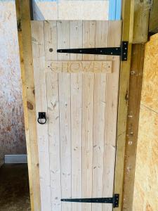 a wooden door with the word champion written on it at Ebb Dome at Estuary Escapes in Kingsbridge