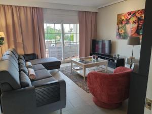 a living room with a couch and a table at Villa Elegante, with a private pool in Murcia