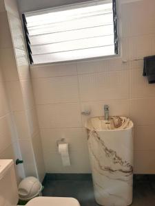a bathroom with a marble sink and a window at Apart Boutique EL DESCANSO in Libertador General San Martín +6 photos