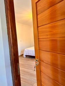 an open door to a bedroom with a bed at Apart Boutique EL DESCANSO in Libertador General San Martín