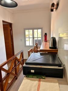 a large black appliance sitting on the floor in a kitchen at Apart Boutique EL DESCANSO in Libertador General San Martín