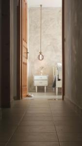 a bathroom with a sink and a desk in a room at Zephyrus Sunset House. Amazing View and Privacy! in Agkidia +75 photos