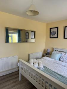 a bedroom with a large bed with towels on it at Erris Ocean House in Belmullet