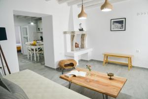 a living room with a table and a kitchen at Kastro View Apartment in Plaka Milou