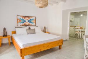 a bedroom with a bed and a dining room at Kastro View Apartment in Plaka Milou