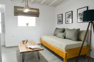 a living room with a couch and a table at Kastro View Apartment in Plaka Milou
