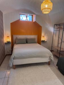a bedroom with a large bed and a window at Le Secret d'Adèle in Chateauroux-les-Alpes