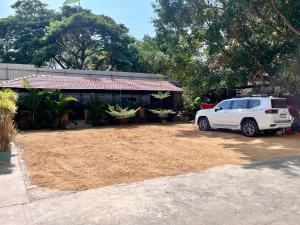 a white truck parked in front of a house at MRP Residency in Chitradurga