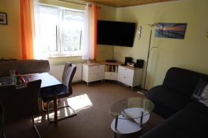 a living room with a couch and a table at Ferienbungalow Meerjungfrau im Seebad Ueckermünde in Ueckermünde